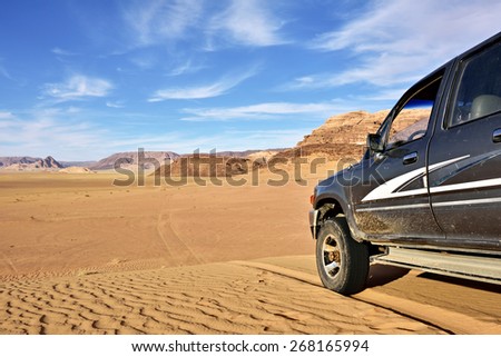 WADI RUM, JORDAN - APR 2, 2015: Off-road car shown in the Wadi Rum desert. Extreme desert safari is one of the main local tourist attraction in Jordan