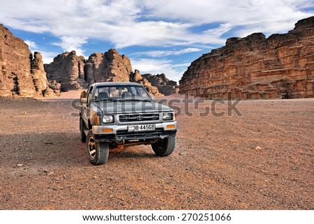 WADI RUM, JORDAN - APR 2, 2015: Off-road car shown in the Wadi Rum desert. Extreme desert safari is one of the main local tourist attraction in Jordan
