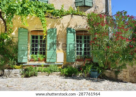 France, Provence. Vaison la Romaine. Typical medieval houses decorated with green plant and flowers in pots.