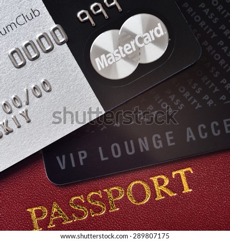 RUSSIA, MOSCOW - FEB 22, 2015: Premium credit card MasterCard Black Edition, Priority Pass card (card for VIP lounge access) and international passport. White background. VIP travel concept