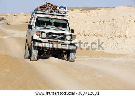 EGYPT, SAHARA - DEC 26, 2008: Off-road car shown in the Tent valley desert. Extreme desert safari is one of the main local tourist attraction in Egypt