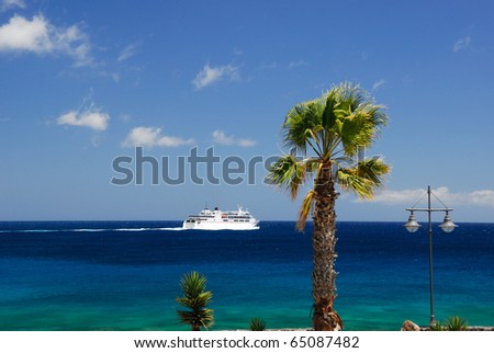 White ship, blue sea and palm tree