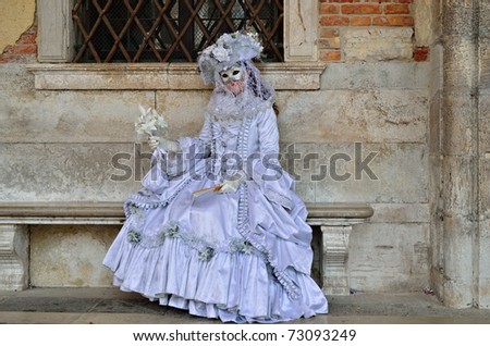 VENICE - MARCH 7: An unidentified masked woman in costume in St. Mark\'s Square during the Carnival of Venice on March 7, 2011. The 2011 carnival was held from February 26th to March 8th.