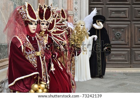 VENICE - MARCH 7: Group of unidentified masked persons in costume in St. Mark\'s Square during the Carnival of Venice on March 7, 2011. The 2011 carnival was held from February 26th to March 8th.