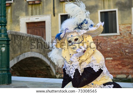 VENICE - MARCH 7: An unidentified masked person in costume near the bridge via Venice canal during the Carnival on March 7, 2011. The 2011 carnival was held from February 26th to March 8th.
