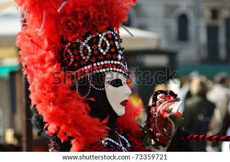 VENICE - MARCH 7: An unidentified masked person in costume in St. Mark\'s Square during the Carnival of Venice on March 7, 2011. The 2011 carnival was held from February 26th to March 8th.