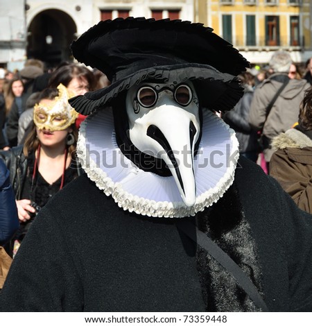 VENICE - MARCH 7: An unidentified masked person in medic costume in St. Mark\'s Square during the Carnival of Venice on March 7, 2011. The 2011 carnival was held from February 26th to March 8th.
