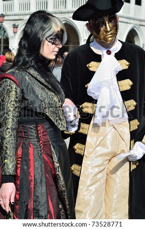 VENICE - MARCH 7: Two unidentified masked persons in costume in St. Mark\'s Square during the Carnival of Venice on March 7, 2011. The 2011 carnival was held from February 26th to March 8th.