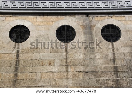 Old wall with 3 circle windows