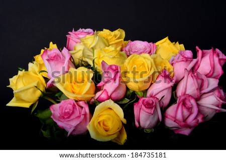 Yellow and pink rose bouquet isolated over black