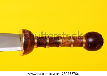 Gladius sword blade, guard, and hilt isolated over yellow