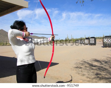Lady at archery range shooting targets