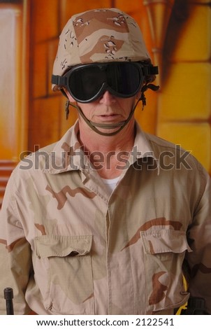 Old soldier wearing desert camouflage and helmet