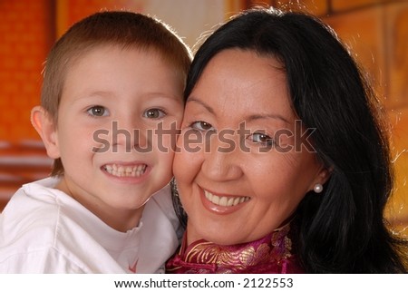 Sexy asian lady wearing a traditional dress holding her son