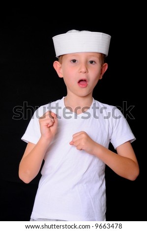 Young boy in a sailor's cap isolated on black