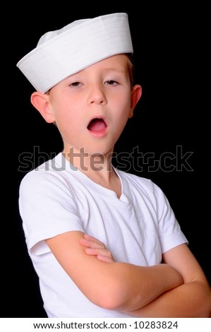 Young boy in a sailor\'s cap isolated on black