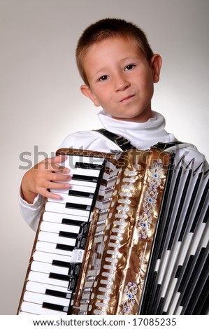 Young boy playing a 48 base accordion