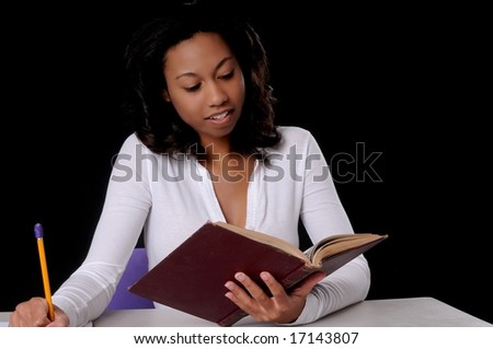 stock photo : Lovely young African American college student studying a book