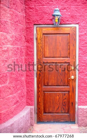 Oak door surrounded by hot pink stone work