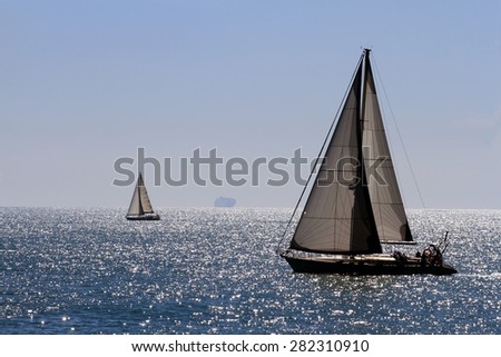 Sail boat in navegation close to the coast of Alicante city