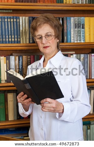 Elderly woman Elderly woman with a book  in a library
