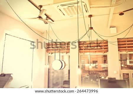 Interior conceptual image. Cafe interior. Windows and ceiling with ventilator and air conditioning.