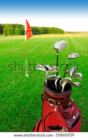 Golf game. Golf clubs in bag against the golf course.