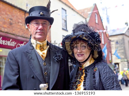 WHITBY, ENGLAND - APRIL 27: Senior man and woman in elegant Goths attire participants at Whitby Gothic Weekend one of the most popular Gothic events in the world.  Whitby 27, April 2013.
