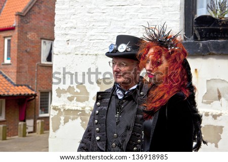 WHITBY, ENGLAND - APRIL 27: Senior man and young woman in Gothic costume participants at  Whitby Gothic Weekend one of the most popular Gothic events in the world.  Whitby 27, April 2013.