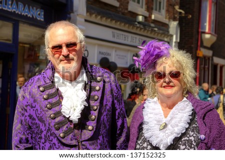 WHITBY, ENGLAND - APRIL 27: Stylish senior man and woman in vintage Goth costume participants at Whitby Gothic Weekend one of the most popular Gothic events in the world. Whitby 27, April 2013.