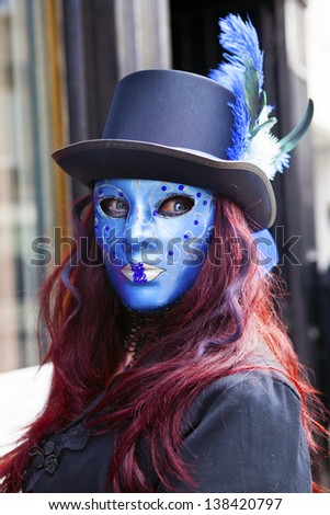 WHITBY, ENGLAND - APRIL 27: Mysterious young female in blue mask and strange contact lenses at Whitby Gothic Weekend one of the most popular Gothic events in the world. Whitby 27, April 2013.