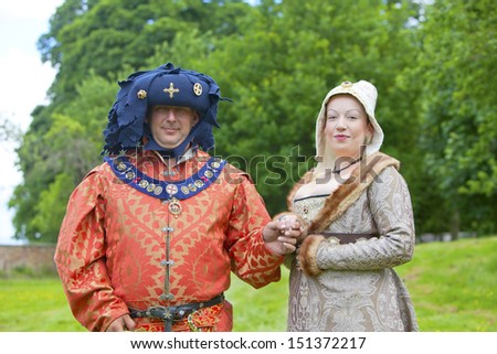 TATTON PARK, ENGLAND - JUNE 15: Man and woman in medieval costume participants at The Medieval Fayre one of the most popular annual events of the Tatton Park in Cheshire, 15, June 2013.