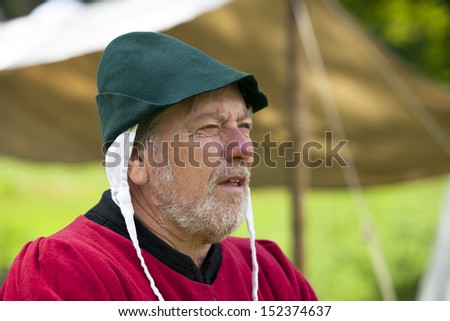 TATTON PARK, ENGLAND - JUNE 15: Character senior man in medieval costume, participant at The Medieval Fayre one of the most popular annual events of the Tatton Park in Cheshire, 15, June 2013.
