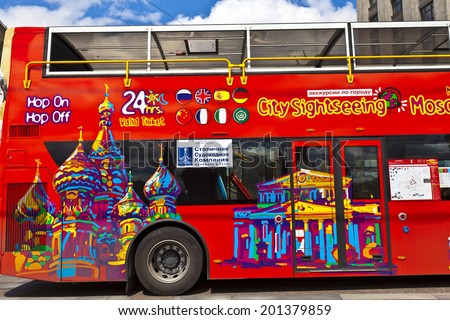 MOSCOW - JUNE 19, 2014: Brightly decorated sightseeing double-decker open top bus in the city centre takes visitors to all the major tourist attractions.
