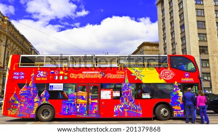 MOSCOW - JUNE 18, 2014: Brightly decorated sightseeing double-decker open top bus in the city centre takes visitors to all the major tourist attractions.