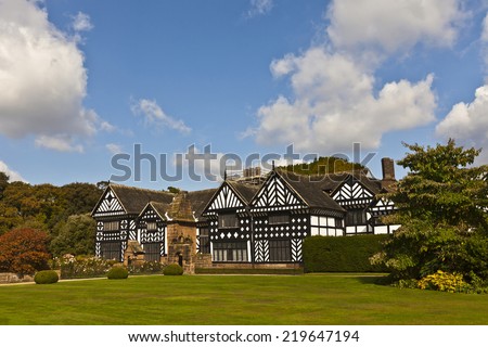 Black and white timber framed medieval mansion house and gardens.