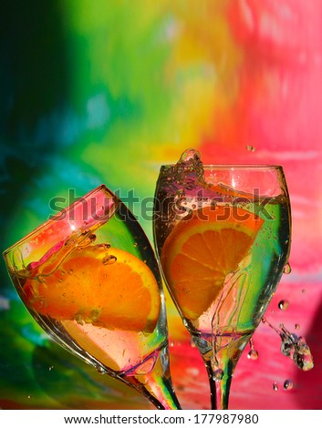 splash of drink with orange, colorful background