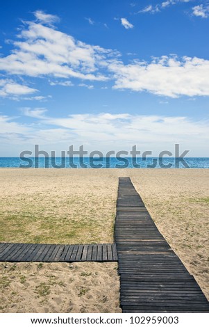 Wooden path to the sandy beach on Costa del Sol in Spain between Marbella and Puerto Banus.
