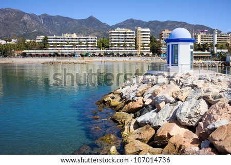 Breakwater on sea bay in popular resort city of Marbella on Costa del Sol in Southern Andalusia, Spain, Malaga province.