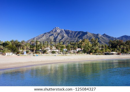 Marbella sandy beach, summer holiday scenery by the Mediterranean Sea in Spain, Andalusia region, Costa del Sol, Malaga province.