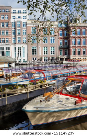 Canal cruise boats on the Amstel river in Amsterdam, Netherlands, North Holland province.