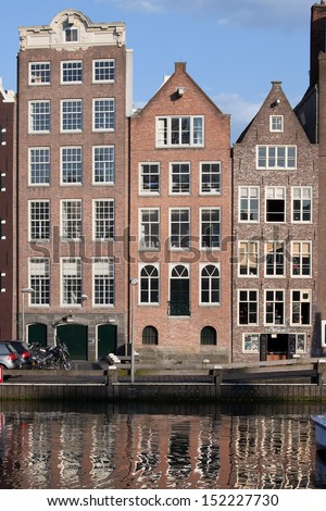 Dutch style row houses by the water in Amsterdam, Holland, Netherlands.