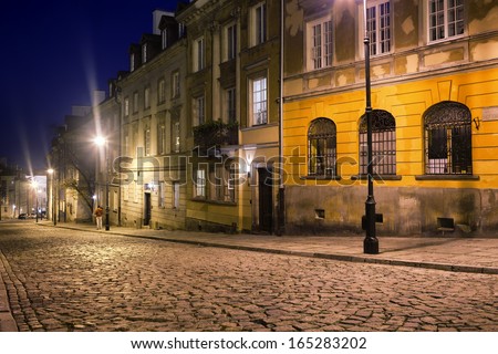 Cobbled Mostowa street at night in the New Town, an old district in Warsaw, Poland.