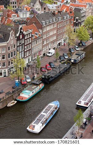 City of Amsterdam from above, Prinsengracht street, cruise boat and houseboats on a canal, Holland, the Netherlands.