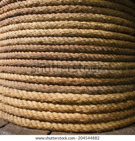 An old coiled, thick, long, strong rope background.
