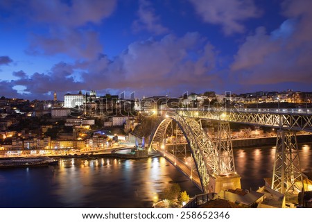 City of Porto by night in Portugal, the Old Town and Ponte Dom Luiz I arch bridge over Douro river.
