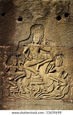 Dancing Apsaras an old Khmer art carvings on the abandonded temple walls in Cambodia.