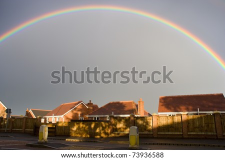 Beautiful rainbow on the stormy sky over a housing estate in Grantham, England, lots of copy space