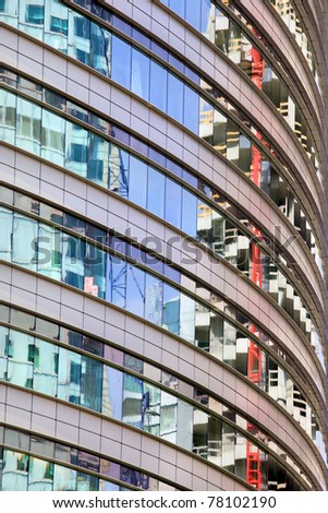 Modern round office building abstract architecture, reflections on windows.