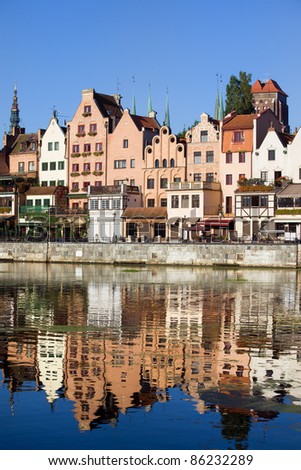 Old Town houses waterfront architecture with reflections on Motlawa river waters in the city of Gdansk, Poland